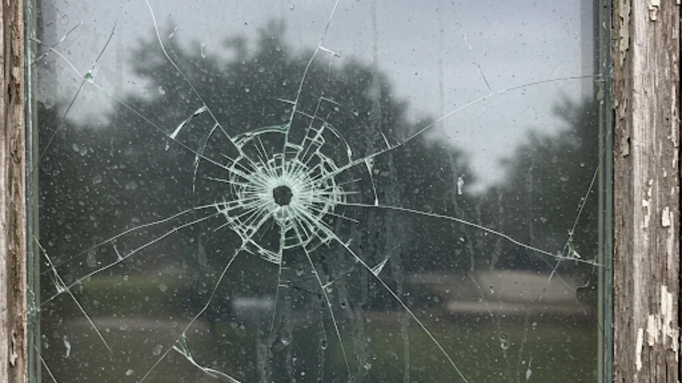 Close-up of damaged window with various types of wear showing Gibraltar's climate impact